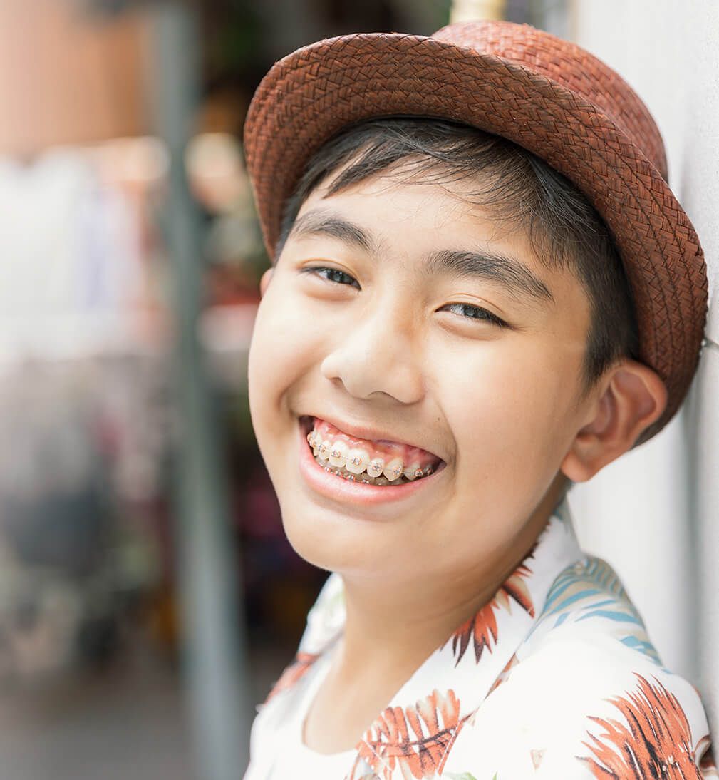 Boy showing a perfect smile with dental braces